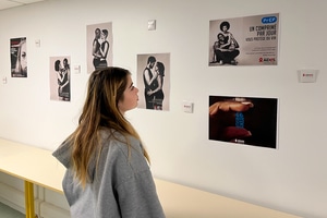 Une jeune fille regarde des affiches de campagne de lutte contre le Sida